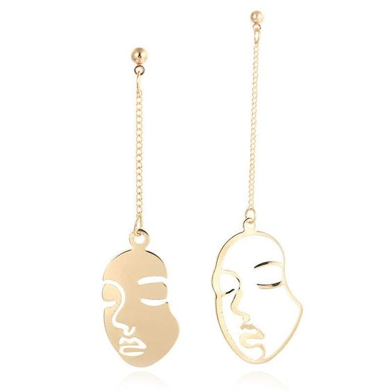 Gold face earrings