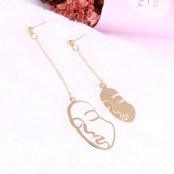 Gold face earrings